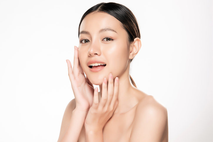 beautiful young woman posing with her hands near her face